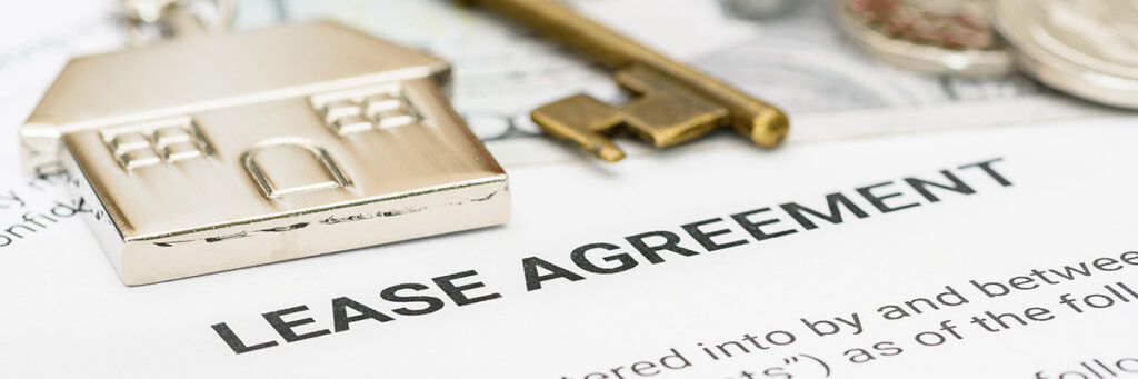 Freehold and Leasehold - Picture showing a lease agreement with a house key and keyring on top.